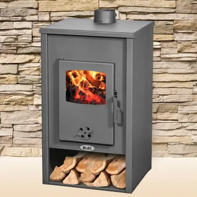 A wood-burning stove with a fire inside, set against a stone wall background.