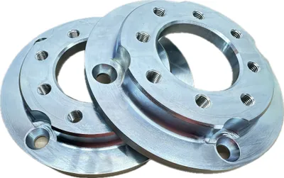 Two metal adapter plates are shown against a white background.