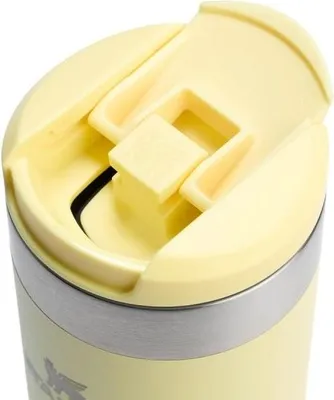 Close-up of the lid of a yellow travel mug.