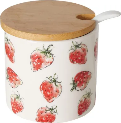 A ceramic container with a strawberry pattern, a wooden lid, and a spoon.