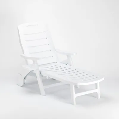 A white plastic sun lounger is shown against a white background.