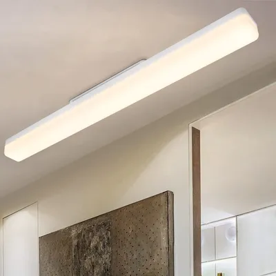 A long, white LED light fixture mounted on a ceiling.