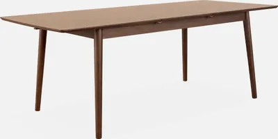 A rectangular dining table with four tapered legs, presented against a plain white background.