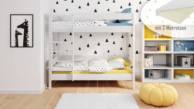 A children's bedroom with a white bunk bed, decorated with black triangle patterns on the wall. There is a framed picture of giraffes on the wall and a yellow pouf on the floor.