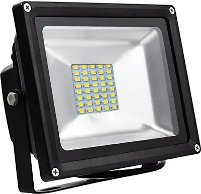 A black LED floodlight with a panel of yellow LEDs visible behind a clear glass cover, mounted on a black bracket.