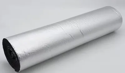 A roll of silver and black insulation material on a light gray background.