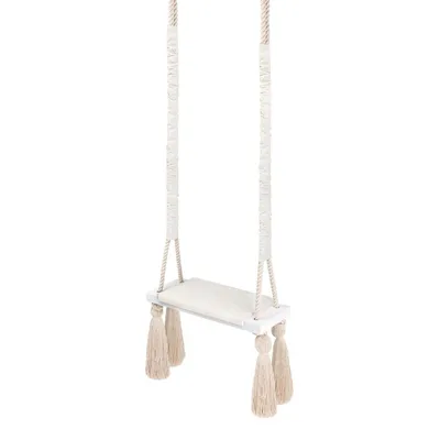 A product shot of a beige and white swing with tassels, isolated on a white background.
