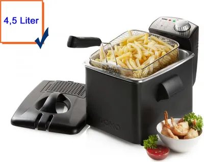 A black deep fryer filled with french fries, with a detached lid and a bowl of fried shrimp in the foreground.