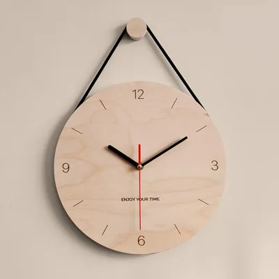 A wooden wall clock hanging on a light-colored wall.