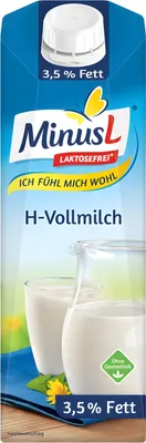 A carton of milk with a jug and glass of milk in the background.