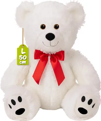 A white teddy bear with a red bow and a green tag indicating its size.