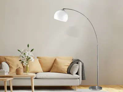 A modern living room scene with a sofa, coffee table, and a floor lamp.