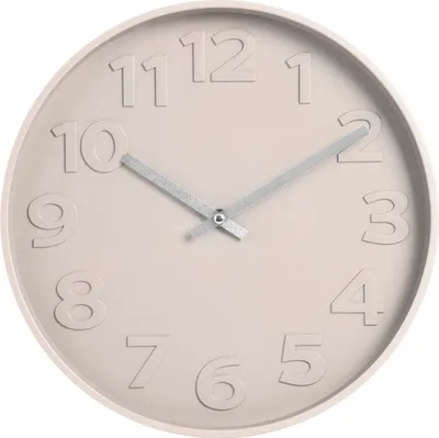 A close-up, front-facing view of a round, beige wall clock with embossed numbers and silver hands.
