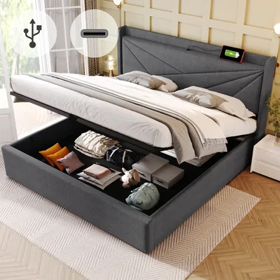 A bed with its storage compartment open, revealing stored items. The bed is in a bedroom setting.