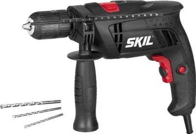 A black and red SKIL brand hammer drill with three drill bits in the foreground.