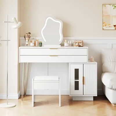 A white vanity table with a mirror, stool, and side cabinet in a bedroom setting.