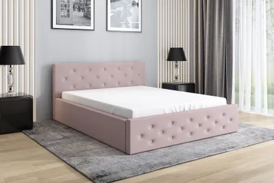 A pink upholstered bed with a white mattress is shown in a bedroom setting.