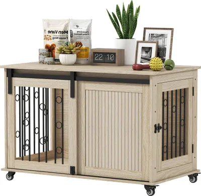 A dog crate furniture piece with decorative items on top.