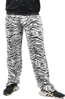 A person wearing zebra-patterned pants and black sneakers.