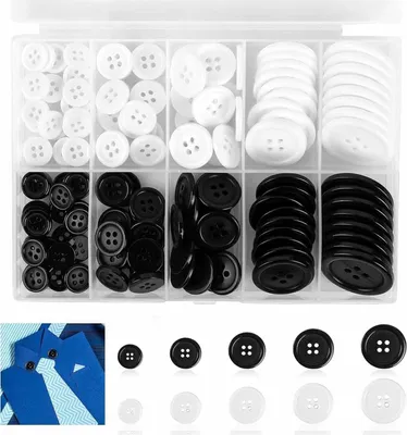 A clear, overhead shot of a plastic organizer box filled with black and white buttons of various sizes.