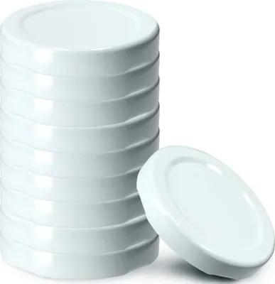 A stack of white jar lids with one lid placed in front of the stack.