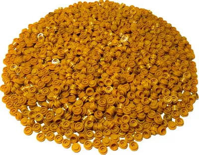 A pile of small, gold-colored LEGO round plates.