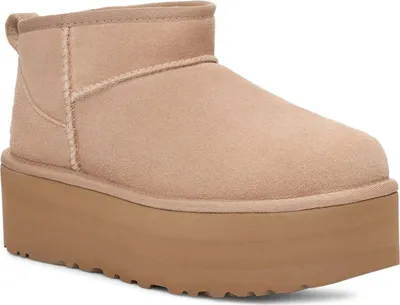 A single UGG boot with a platform sole is shown against a white background.