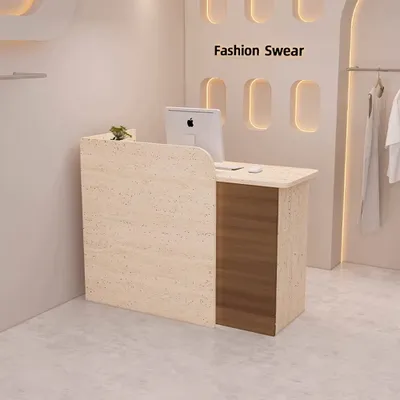 A reception desk in a retail store with clothing racks in the background.