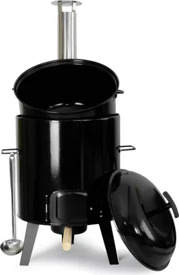 A black outdoor cooking stove with a chimney and a detached lid.