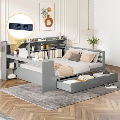 A grey daybed with a bookshelf and desk attachment is shown in a bedroom setting.