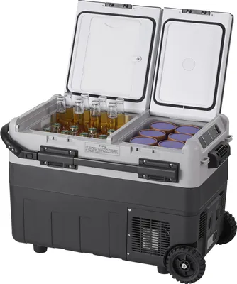A portable refrigerator with its lid open, showing bottles and containers inside.