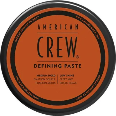 A top-down view of a round container of American Crew Defining Paste.
