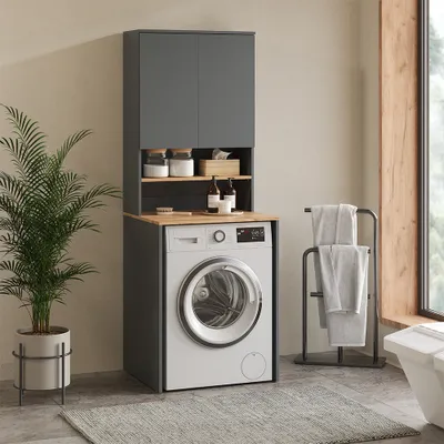 A laundry room setup with a washing machine and storage cabinets.