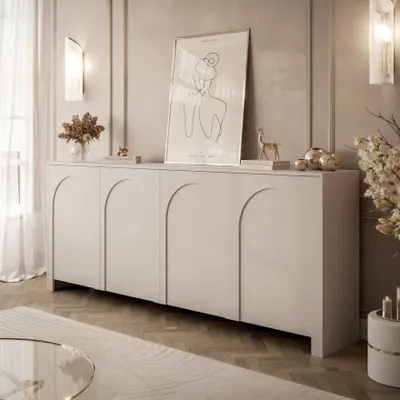 A modern living room with a light gray sideboard, artwork, and decorative items.