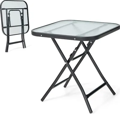 A square glass-top folding table with a black metal frame, shown both set up and folded.