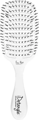A white hairbrush with black bristles is shown against a white background.