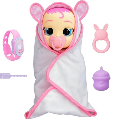 A baby doll wrapped in a white blanket with pink trim, surrounded by accessories.