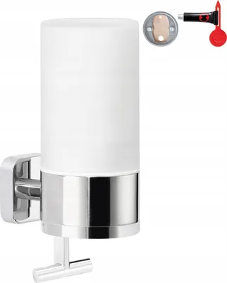 A wall-mounted liquid soap dispenser with a frosted glass container and a chrome base.