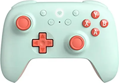A mint green and coral colored game controller is shown from a front-facing, slightly elevated angle against a white background.