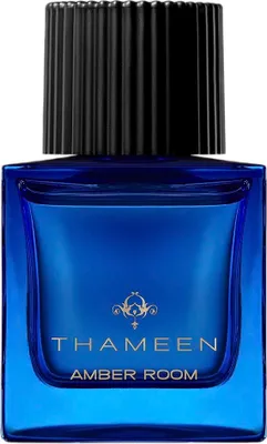 A close-up studio shot of a blue glass perfume bottle with a black ribbed cap.