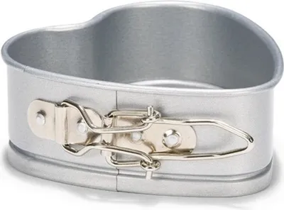 A heart-shaped cake pan with a silver finish and a detachable side.