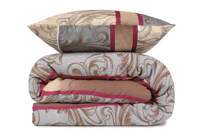 A neatly folded duvet and pillow with a patterned design.