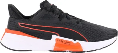 A side view of a black and orange Puma training shoe against a white background.