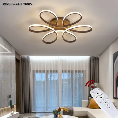 A modern living room with a stylish ceiling lamp and a remote control.