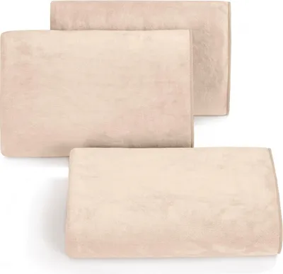 Three beige towels are stacked on a white background.