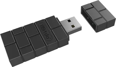 A black wireless Bluetooth adapter with its cap removed, shown on a white background.