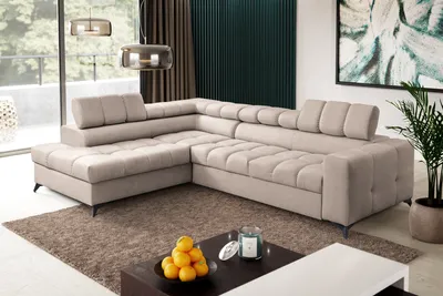 A modern living room with a large sectional sofa, coffee table, and artwork.
