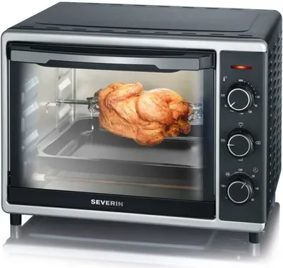 A Severin mini oven with a whole roasted chicken on a rotisserie inside.