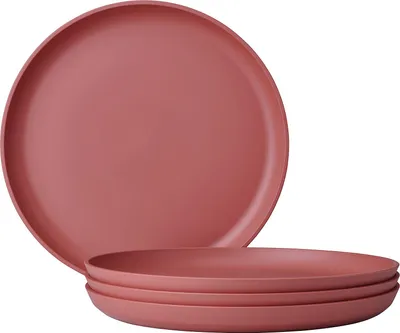 A stack of pink plates on a white background.