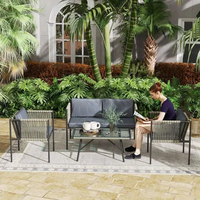 Image de Ensemble de mobilier de jardin 4 pièces – 1 canapé, 2 fauteuils et une table avec plateau en verre, coussins, structure en acier et rotin synthétique inclus, gris